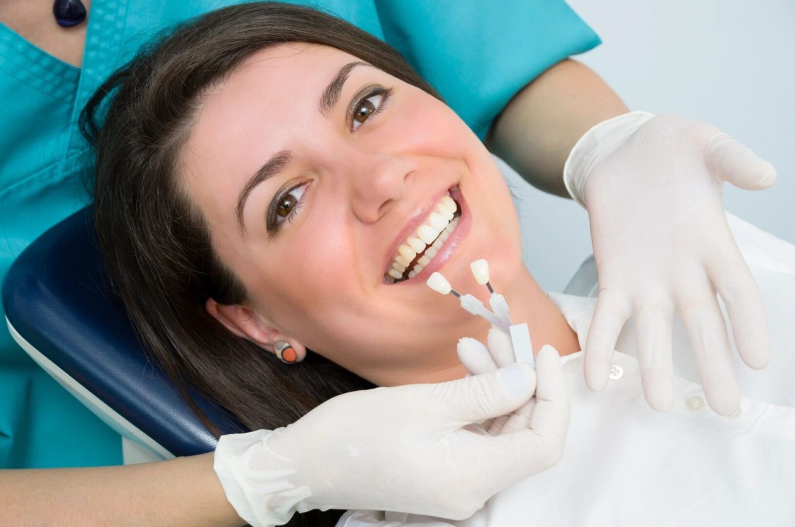 A woman with white gloves on and smiling.