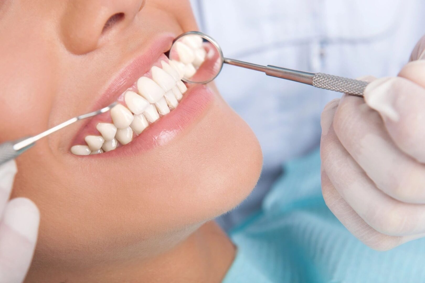 A person is getting their teeth checked by an dentist.